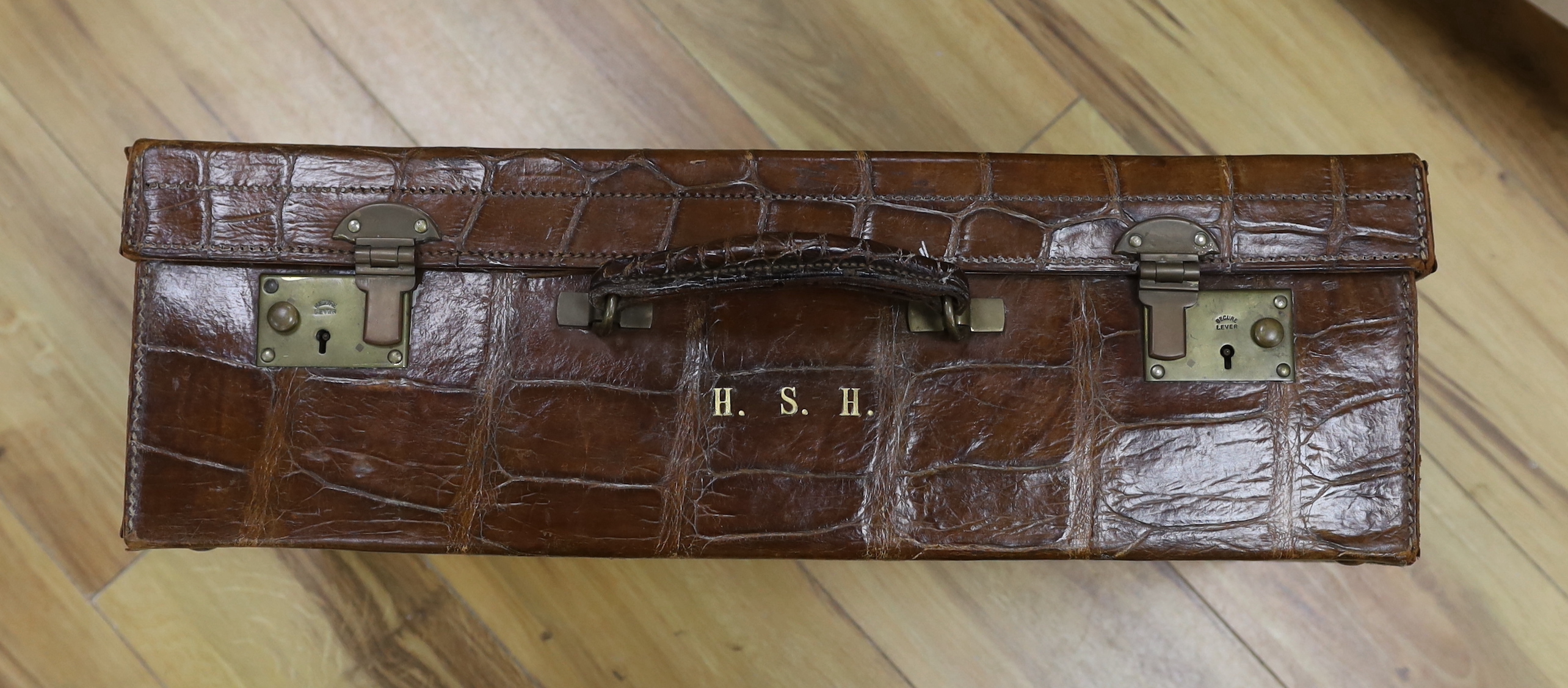 A Vintage 1930’s crocodile skin travelling case, 56cm wide